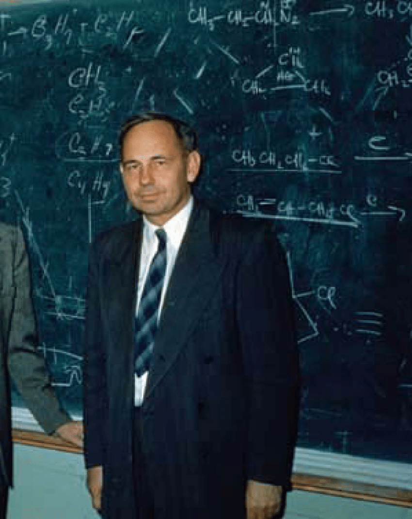 Henry Eyring standing in front of a chalkboard full of equations